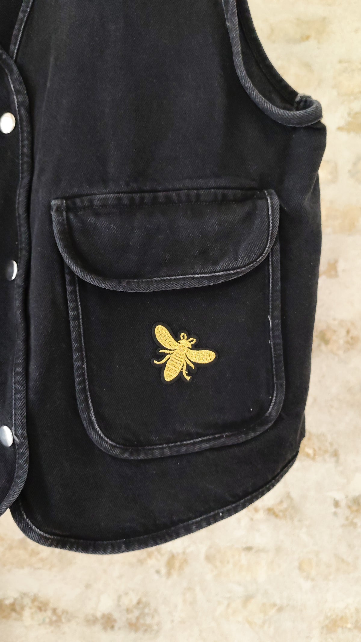Détail écusson abeille dorée brodée sur poche de veste noire – BFunny
